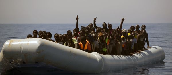 Migrants and refugees call out to Spanish NGO Proactiva Open Arms workers, after being located out of control sailing on a rubber boat in the Mediterranean Sea, about 18 miles north of Sabratha, Libya - Sputnik International