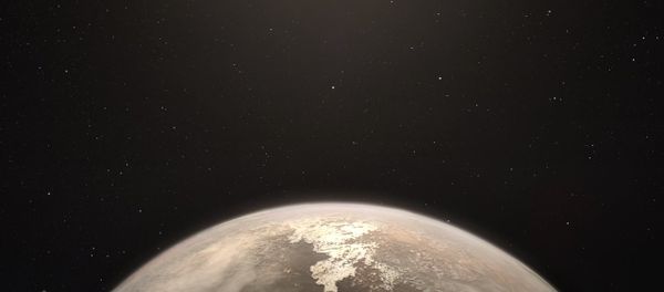 This artist’s impression shows the temperate planet Ross 128 b, with its red dwarf parent star in the background. - Sputnik International