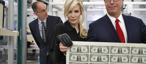Treasury Secretary Steven Mnuchin, right, and his wife Louise Linton, hold up a sheet of new $1 bills, the first currency notes bearing his and U.S. Treasurer Jovita Carranza's signatures, Wednesday, Nov. 15, 2017, at the Bureau of Engraving and Printing (BEP) in Washington. Treasury Secretary Steven Mnuchin, right, and his wife Louise Linton, hold up a sheet of new $1 bills, the first currency notes bearing his and U.S. Treasurer Jovita Carranza's signatures, Wednesday, Nov. 15, 2017, at the Bureau of Engraving and Printing (BEP) in Washington. - Sputnik International