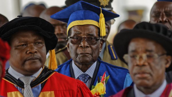 Zimbabwe's President Robert Mugabe, center, arrives to preside over a student graduation ceremony at Zimbabwe Open University on the outskirts of Harare, Zimbabwe Friday, Nov. 17, 2017 Zimbabwe's President Robert Mugabe, center, arrives to preside over a student graduation ceremony at Zimbabwe Open University on the outskirts of Harare, Zimbabwe Friday, Nov. 17, 2017 - Sputnik International