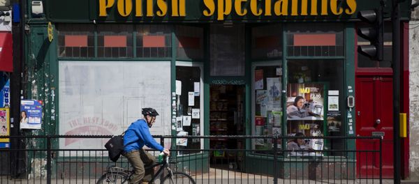A man as he cycles past a Polish Specialties shop in London. - Sputnik International
