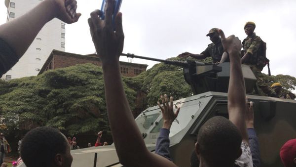 People begin to gather around a military vehicle in Harare Saturday, Nov. 18, 2017, demonstrating for the ouster of 93-year-old president Robert Mugabe who is virtually powerless and deserted by most of his allies People begin to gather around a military vehicle in Harare Saturday, Nov. 18, 2017, demonstrating for the ouster of 93-year-old president Robert Mugabe who is virtually powerless and deserted by most of his allies - Sputnik International