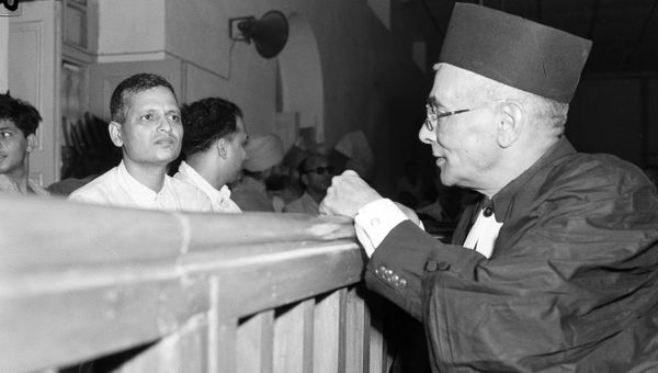 Nathuram Godse, left, one of nine co-defendants in the Mohandas Gandhi assassination conspiracy case, and defense counsellor L.B. Bhopatkar confer May 27, 1948, at the start of the hearing Nathuram Godse, left, one of nine co-defendants in the Mohandas Gandhi assassination conspiracy case, and defense counsellor L.B. Bhopatkar confer May 27, 1948, at the start of the hearing - Sputnik International