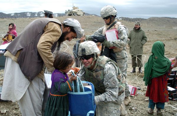 In this US Miltary Handout picture taken, 16 March 2007, U.S soldiers with the NATO-led International Security Assistance Force (ISAF) distribute school stationery to Afghan children in Orgun in eastern Afghanistan In this US Miltary Handout picture taken, 16 March 2007, U.S soldiers with the NATO-led International Security Assistance Force (ISAF) distribute school stationery to Afghan children in Orgun in eastern Afghanistan - Sputnik International