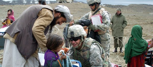In this US Miltary Handout picture taken, 16 March 2007, U.S soldiers with the NATO-led International Security Assistance Force (ISAF) distribute school stationery to Afghan children in Orgun in eastern Afghanistan In this US Miltary Handout picture taken, 16 March 2007, U.S soldiers with the NATO-led International Security Assistance Force (ISAF) distribute school stationery to Afghan children in Orgun in eastern Afghanistan - Sputnik International