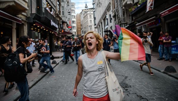A LGBT member waves a rainbow flag during a rally staged by the LGBT community on Istiklal avenue in Istanbul on June 26, 2016 A LGBT member waves a rainbow flag during a rally staged by the LGBT community on Istiklal avenue in Istanbul on June 26, 2016 - Sputnik International
