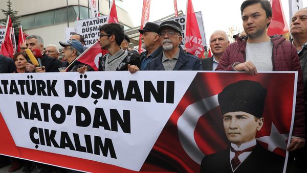 Protestors wave flags and carry a banner during a demonstration against NATO military exercises on November 18, 2017 in Ankara Protestors wave flags and carry a banner during a demonstration against NATO military exercises on November 18, 2017 in Ankara - Sputnik International