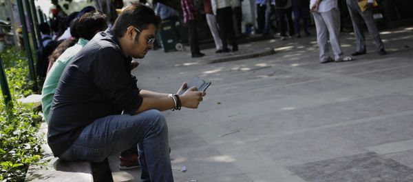 An Indian man uses his mobile phone in New Delhi, India. (File) - Sputnik International