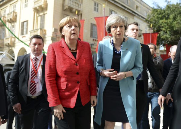 German Chancellor Angela Merkel, left, speaks with British Prime Minister Theresa May, right, as they walk with other EU leaders during an event at an EU summit in Valletta, Malta, on Friday, Feb. 3, 2017. - Sputnik International