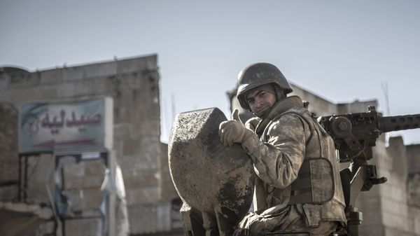 In this February 22, 2015, file photo, a soldier gives the thumbs up as Turkish army's armored vehicles and tanks roll in Syrian town of Ayn al-Arab, also known as Kobani, as they return from the Ottoman tomb in Syria.  - Sputnik International