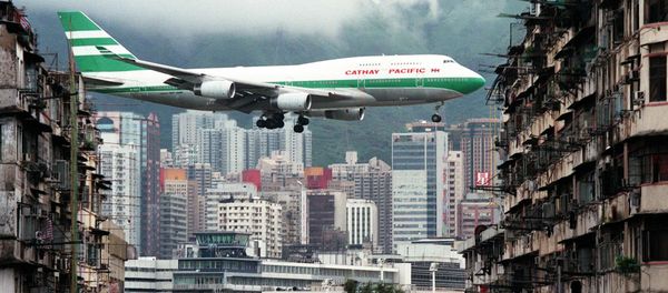 Hong Kong flag carrier Cathay Pacific, Boeing 747-400 jumbo jet, flies over the Kai Tak Airport control tower bottom as it approaches the Runway 13 on the last day of the 73-year-old airport - Sputnik International