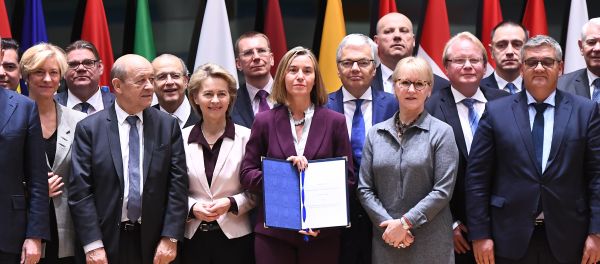 European Union foreign policy chief Federica Mogherini, center, poses with EU foreign and defense ministers after signing the notification on Permanent Structure Cooperation (PESCO) on the margin of a foreign affairs council at the Europa building in Brussels - Sputnik International