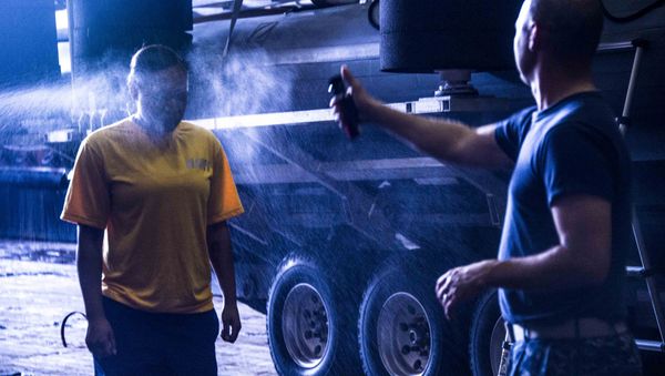 US Navy Operations Specialist gets a face-full of pepper spray before starting training aboard USS Ponce during the International Mine Countermeasures Exercise. - Sputnik International