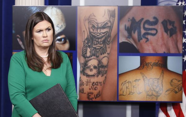 White House press secretary Sarah Huckabee Sanders stands in front of pictures of MS-13 gang tattoos during a press briefing at the White House in Washington, Thursday, July 27, 2017. - Sputnik International