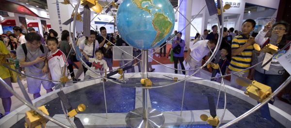 Visitors look at a mockup of China's homegrown Beidou satellite navigation system at the China Beijing International High-Tech Expo in Beijing, Saturday, June 10, 2017 - Sputnik International
