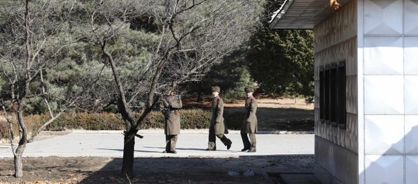 Three North Korean soldiers look at the South side at the spot where a North Korean soldier crossed the border at the Panmunjom in the Demilitarized Zone, South Korea Three North Korean soldiers look at the South side at the spot where a North Korean soldier crossed the border at the Panmunjom in the Demilitarized Zone, South Korea - Sputnik International