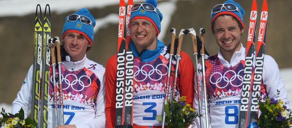 Medalists in the mass start race in men’s cross country skiing at the XXII Olympic Winter Games in Sochi during the flower ceremony, from left: silver medalist Maxim Vylegzhanin (Russia); gold medalist Alexander Legkov (Russia); bronze medalist Ilya Chernousov (Russia). (File) Medalists in the mass start race in men’s cross country skiing at the XXII Olympic Winter Games in Sochi during the flower ceremony, from left: silver medalist Maxim Vylegzhanin (Russia); gold medalist Alexander Legkov (Russia); bronze medalist Ilya Chernousov (Russia). (File) - Sputnik International