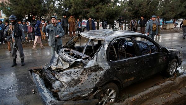 People look on at a damaged vehicle after a suicide bomb attack in Kabul, Afghanistan November 16, 2017 People look on at a damaged vehicle after a suicide bomb attack in Kabul, Afghanistan November 16, 2017 - Sputnik International