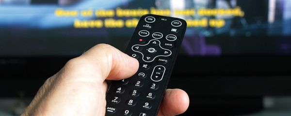 A man holding a remote control, watching TV A man holding a remote control, watching TV - Sputnik International