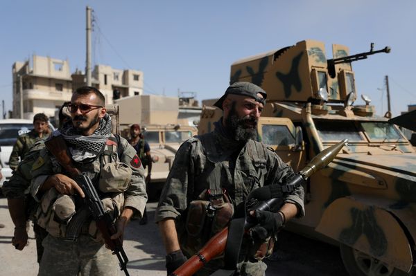 A fighter of the Syrian Democratic Forces (SDF) carries a weapon as he stands near a military vehicle in Raqqa, Syria, October 16, 2017 A fighter of the Syrian Democratic Forces (SDF) carries a weapon as he stands near a military vehicle in Raqqa, Syria, October 16, 2017 - Sputnik International