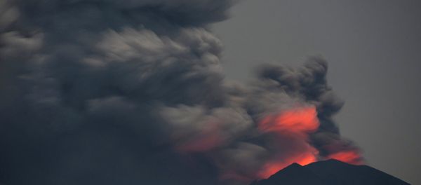 Light from lava inside the crater is reflected off volcanic ash from Mount Agung, as seen from Jemeluk Beach, Karangasem, Bali, Indonesia November 28, 2017 in this photo taken by Antara Foto. Picture taken November 28, 2017 - Sputnik International
