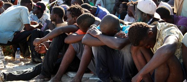 Illegal migrants from sub-Saharan Africa rest after they were rescued by the Libyan coast guard when their boat sank off the coastal town of Guarabouli, 60 km (36 miles) east of the capital Tripoli on October 2, 2014 Illegal migrants from sub-Saharan Africa rest after they were rescued by the Libyan coast guard when their boat sank off the coastal town of Guarabouli, 60 km (36 miles) east of the capital Tripoli on October 2, 2014 - Sputnik International
