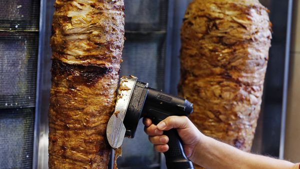 A man slices cuts of meat from a rotisserie Doner (photo used for illustration purpose) - Sputnik International