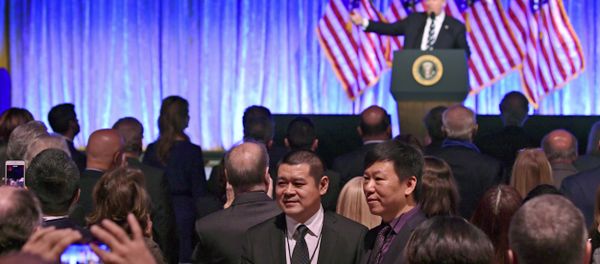 People in the audience have their photo taken as President Donald Trump speaks at a fundraiser - Sputnik International