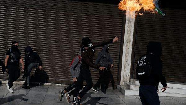 A hooded youth throws a petrol bomb to riot police during an anniversary rally marking the 2008 police shooting of 15-year-old student Alexandros Grigoropoulos, in Athens, Greece A hooded youth throws a petrol bomb to riot police during an anniversary rally marking the 2008 police shooting of 15-year-old student Alexandros Grigoropoulos, in Athens, Greece - Sputnik International