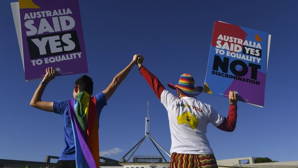 Same-sex marriage campaigners pose for pictures during an equality rally outside Parliament House in Canberra December 7, 2017 - Sputnik International
