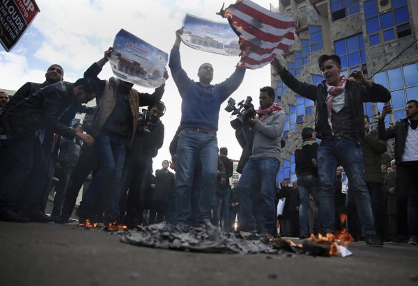 Palestinian protesters chant angry slogans as one burns a representation of the American flag, during a protest against the U.S. decision to recognize Jerusalem as Israel's capital, in Gaza City Thursday, Dec. 7, 2017 - Sputnik International