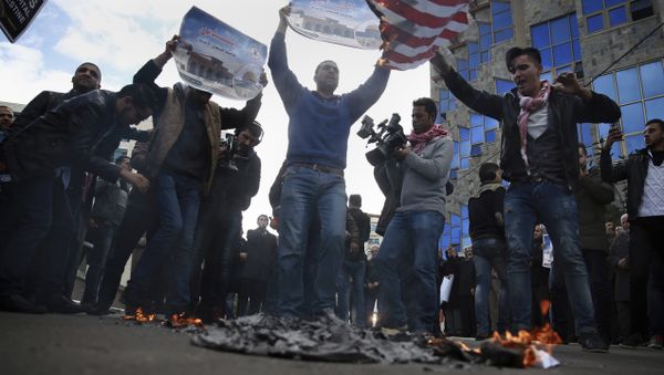Palestinian protesters chant angry slogans as one burns a representation of the American flag, during a protest against the U.S. decision to recognize Jerusalem as Israel's capital, in Gaza City Thursday, Dec. 7, 2017 - Sputnik International