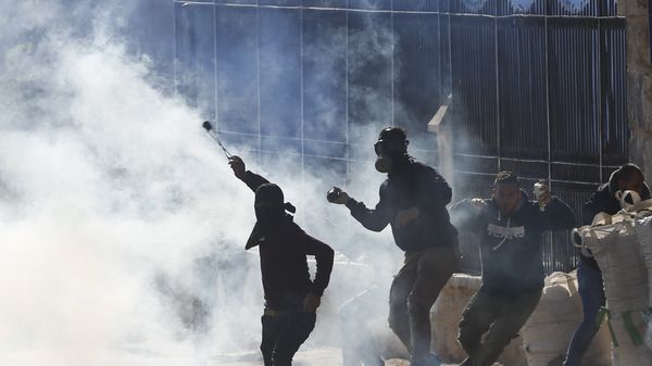 Palestinians clash with Israeli troops during a protest against U.S. President Donald Trump's decision to recognize Jerusalem as the capital of Israel in the West Bank city of Bethlehem, Friday, Dec.8, 2017 - Sputnik International