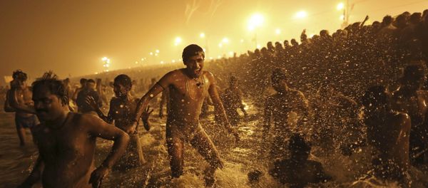 In this Jan. 14, 2013 file photo, an Indian Hindu man jumps up and down in the water as he takes a dip at Sangam, the confluence of the Ganges, Yamuna and mythical Saraswati River, during the royal bath on Makar Sankranti at the start of the Maha Kumbh Mela in Allahabad, India - Sputnik International