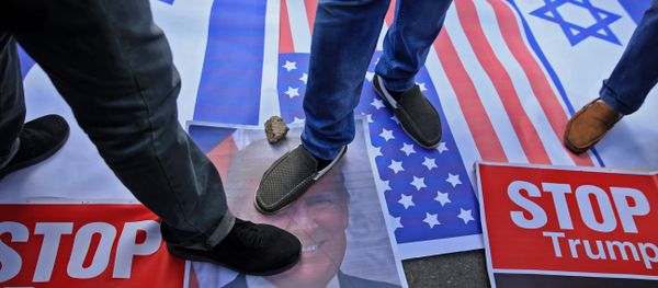 Palestinian protesters step on US and Israeli flags and on a portrait of US President Donald Trump following his decision to recognise Jerusalem as the capital of Israel, in Gaza City - Sputnik International