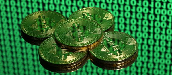 Tokens of the virtual currency Bitcoin are seen placed on a monitor that displays binary digits in this illustration picture, December 8, 2017 Tokens of the virtual currency Bitcoin are seen placed on a monitor that displays binary digits in this illustration picture, December 8, 2017 - Sputnik International