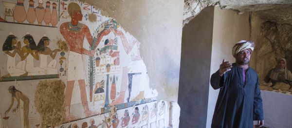 An Egyptian guard stands next to a funeral mural inside a newly discovered tomb on Luxor's West Bank known as KAMPP 161 during an announcement for the Egyptian Ministry of antiquities about new discoveries in Luxor, Egypt, Saturday, Dec. 9, 2017 - Sputnik International