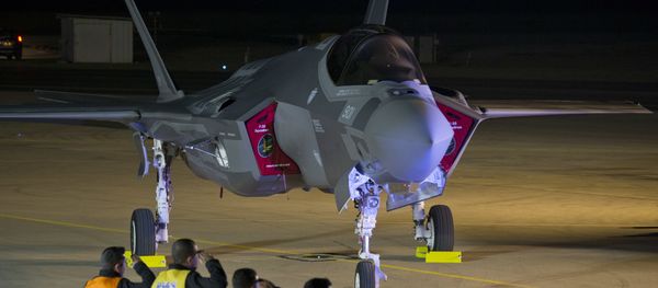 Israeli air force officers salute toward one of the first two next-generation F-35 fighter jets during an unveiling ceremony after it landed in Nevatim Air Force base near Beersheba, Southern Israel, Monday, Dec. 12, 2016 - Sputnik International