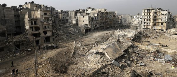In this picture taken Friday, Jan. 20, 2017 from the balcony of the Abdul-Hamid Khatib home, people walk through mounds of rubble which used to be high rise apartment buildings in the once rebel-held Ansari neighborhood in the eastern Aleppo, Syria - Sputnik International