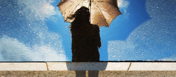 A silhouette of a woman holding an umbrella A silhouette of a woman holding an umbrella - Sputnik International