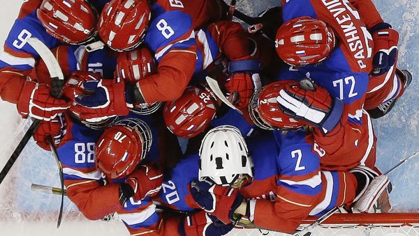 Members of Team Russia hug after defeating Japan 6-3 during the 2014 Winter Olympics women's ice hockey game at Shayba Arena Sunday, Feb. 16, 2014, in Sochi, Russia Members of Team Russia hug after defeating Japan 6-3 during the 2014 Winter Olympics women's ice hockey game at Shayba Arena Sunday, Feb. 16, 2014, in Sochi, Russia - Sputnik International