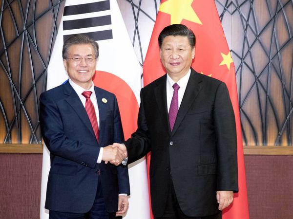 In this Nov. 11, 2017, photo released by China's Xinhua News Agency, South Korean President Moon Jae-in, left, and Chinese President Xi Jinping shake hands as they pose for a photo during a meeting on the sidelines of the Asia-Pacific Economic Cooperation (APEC) Forum in Danang, Vietnam. In this Nov. 11, 2017, photo released by China's Xinhua News Agency, South Korean President Moon Jae-in, left, and Chinese President Xi Jinping shake hands as they pose for a photo during a meeting on the sidelines of the Asia-Pacific Economic Cooperation (APEC) Forum in Danang, Vietnam. - Sputnik International