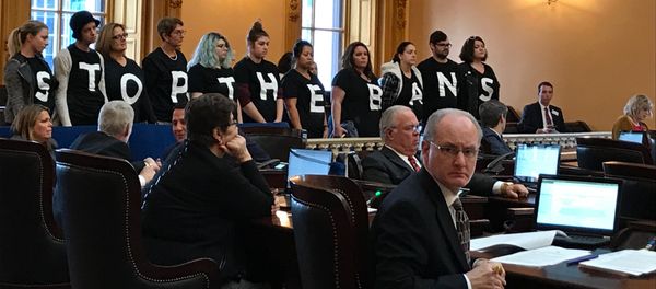 Abortion-rights activists stand in protest on Wednesday, Dec. 13, 2017, in the Ohio Senate chamber in Columbus, after passage of a bill banning abortions in cases of a Down syndrome diagnosis - Sputnik International