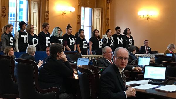 Abortion-rights activists stand in protest on Wednesday, Dec. 13, 2017, in the Ohio Senate chamber in Columbus, after passage of a bill banning abortions in cases of a Down syndrome diagnosis Abortion-rights activists stand in protest on Wednesday, Dec. 13, 2017, in the Ohio Senate chamber in Columbus, after passage of a bill banning abortions in cases of a Down syndrome diagnosis - Sputnik International