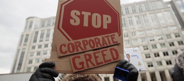 A woman hold a sign that reads Stop Corporate Greed during a protest at the Federal Communications Commission (FCC), in Washington, Thursday, Dec. 14, 2017 A woman hold a sign that reads Stop Corporate Greed during a protest at the Federal Communications Commission (FCC), in Washington, Thursday, Dec. 14, 2017 - Sputnik International