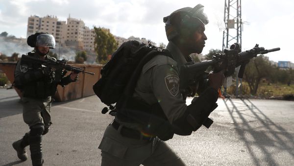 Israeli border policemen run towards Palestinian protesters during a protest against U.S. President Donald Trump's decision to recognize Jerusalem as the capital of Israel, near the Jewish settlement of Beit El, near the West Bank city of Ramallah December 14, 2017 - Sputnik International