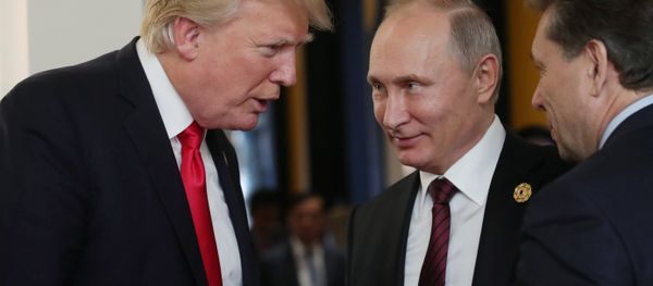 Russian President Vladimir Putin and US President Donald Trump, left, are seen here during a break in a working session at the Asia-Pacific Economic Cooperation Economic Leaders' Meeting - Sputnik International