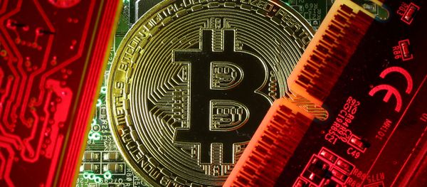 A coin representing the bitcoin cryptocurrency is seen on computer circuit boards in this illustration picture, October 26, 2017 - Sputnik International