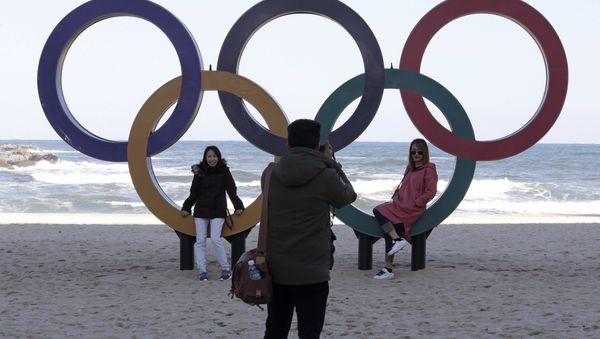 This Oct. 30, 2017, photo show visitors posing with the Olympic Rings at the Gyeongpodae beach, in Gangneung, South Korea - Sputnik International