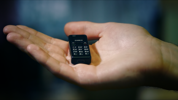 The Zanco Tiny T1 phone held in the palm of a hand - Sputnik International